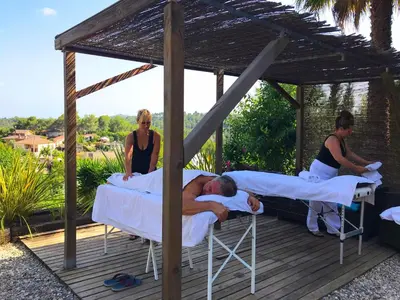 a group of people laying on beds in a gazebo at Casa Mallarenga Rooms in Olivella