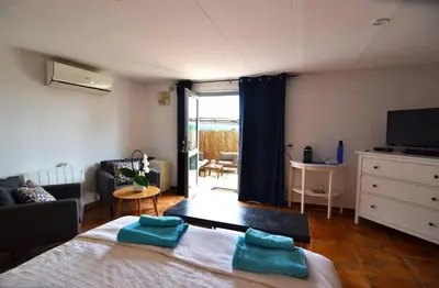 a bedroom with a bed and a living room at Casa Mallarenga Rooms in Olivella