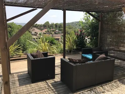 two couches sitting on a deck with a view at Casa Mallarenga Rooms in Olivella