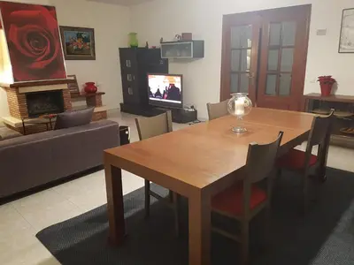 a living room with a wooden table and a couch at Vil·la La Garriga Termal Congost in La Garriga