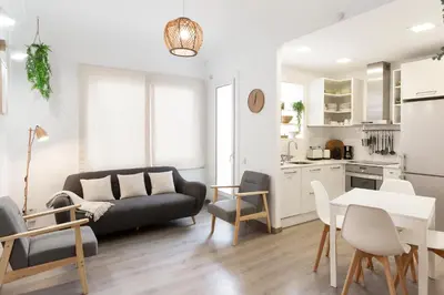 a living room with a couch and a table at KeyFamily Cozy Home in Barcelona