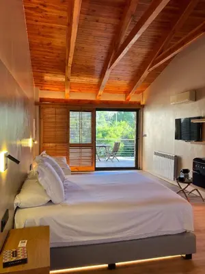 a large bed in a room with a large window at Boutique hotel Urbisol in Calders
