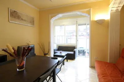 a living room with a table and a couch at Good-Apartments Barcelona in Barcelona