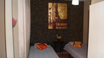 a room with two beds and a painting on the wall at Good-Apartments Barcelona in Barcelona