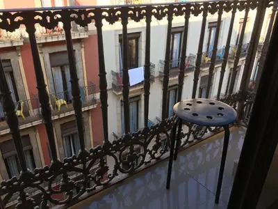 a chair sitting on a balcony of a building at La Terrassa in Barcelona