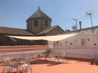 a patio with a table and chairs and a building at La Terrassa in Barcelona