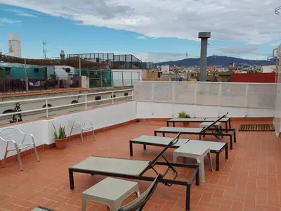 a group of tables and chairs on a roof at La Terrassa in Barcelona