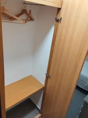 a closet with a wooden door and a desk at La Terrassa in Barcelona