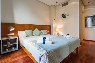 a bedroom with a bed with a blue ribbon on it at Habitat Apartments Paseo de Gracia Suite in Barcelona