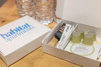 a box with a pack ofmatching products on a table at Habitat Apartments Paseo de Gracia Suite in Barcelona