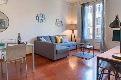 a living room with a couch and a table at Habitat Apartments Paseo de Gracia Suite in Barcelona