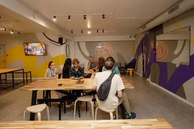 a group of people sitting at a table in a room at Onefam Les Corts in Barcelona