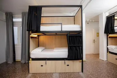 two bunk beds in a room with a room with another bed at Onefam Les Corts in Barcelona