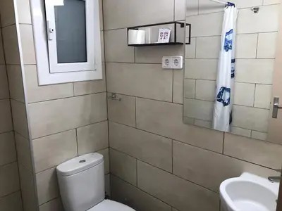 a bathroom with a toilet and a sink and a mirror at Hostal Radio Barcelona in Barcelona