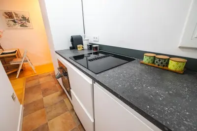 a kitchen with a stove and a counter top at RentBCN Park Guell in Barcelona