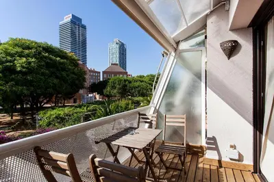 a balcony with a wooden table and chairs on it at 1324 - OLYMPIC DELUXE in Barcelona