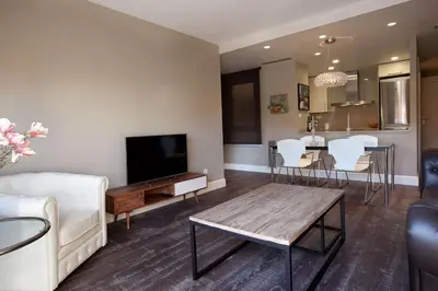 a living room with a couch and a tv at Calabria Luxury in Barcelona