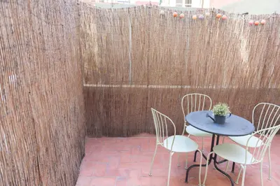 a patio with a table and chairs and a fence at Sweet BCN Studio with Terrace in Barcelona