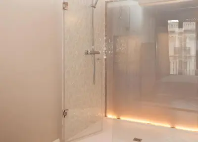 a shower with a glass door with lights in a bathroom at Trafalgar Luxury in Barcelona