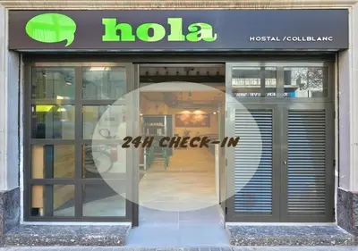 a store front with a large glass door at Hola Hostal Collblanc in Hospitalet de Llobregat