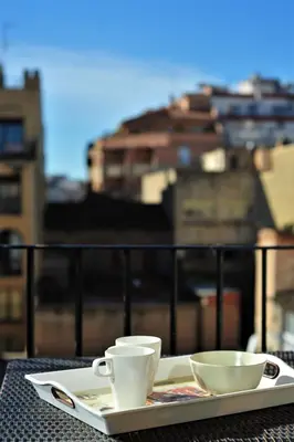 a tray with two coffee cups on a table at Apartamentos Bejar in Barcelona