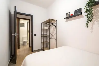 a bedroom with a bed and a bathroom with a toilet at Beach Apartment, next to the sea in Premiá de Mar