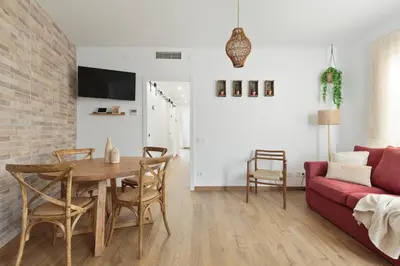 a living room with a table and a couch at KeyFamily Sweet Home in Barcelona