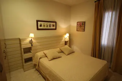a bedroom with a bed with two pillows on it at Apartaments St. Jordi Comtal in Barcelona
