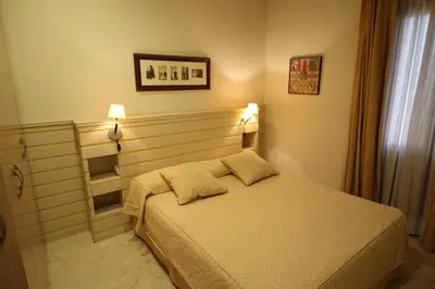 a bedroom with a bed with two pillows on it at Apartaments St. Jordi Comtal in Barcelona