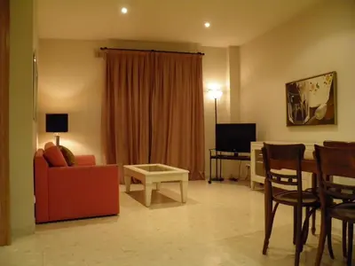 a living room with a red couch and a table at Apartaments St. Jordi Comtal in Barcelona