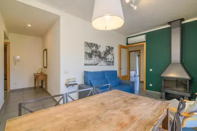 a living room with a blue couch and a table at Apartaments Rural Montseny in gualba de Dalt