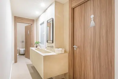 a bathroom with a sink and a wooden door at Casa Lirio in Barcelona