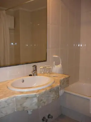 a bathroom with a sink and a bath tub at Hotel Haromar in Calella