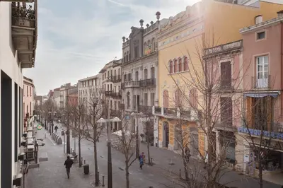 a city street with buildings and people walking down the street at Matarolux 14 in Mataró