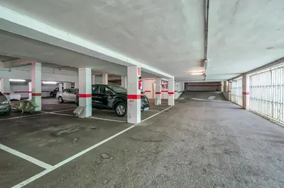 an empty parking garage with cars parked in it at Hauzify I Apartaments Sot del Morer in San Pol de Mar