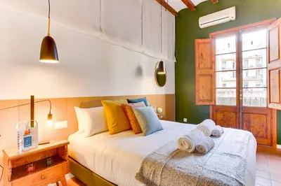a bedroom with a bed with towels on it at Sweett - Ausias Marc in Barcelona