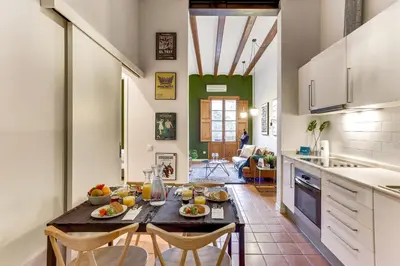 a kitchen and dining room with a table and chairs at Sweett - Ausias Marc in Barcelona