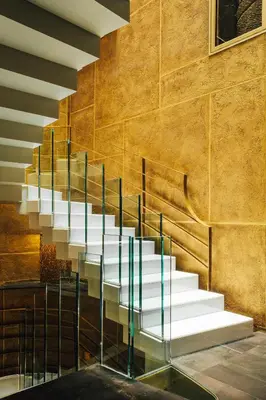 a staircase with glass railings in a building at Hotel Bagués, a Small Luxury Hotel of the World in Barcelona
