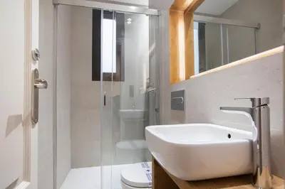 a bathroom with a sink and a shower and a toilet at Tendency Sagrada Familia Luxury in Barcelona
