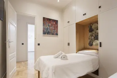 a bedroom with a bed and a painting on the wall at Tendency Sagrada Familia Luxury in Barcelona