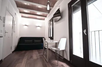 a room with a table and chairs and a couch at Barcelona Beach Apartments in Barcelona
