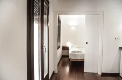 a room with a bedroom with a bed and a mirror at Barcelona Beach Apartments in Barcelona