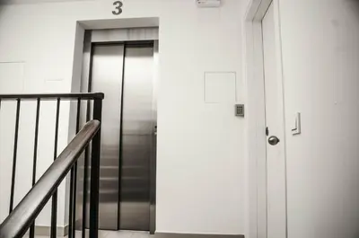 an elevator in a building with the number three on it at Barcelona Beach Apartments in Barcelona