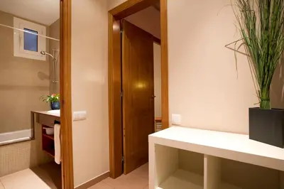 a bathroom with a sink and a shower with a plant at BCNGOTIC 13 in Barcelona