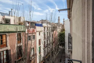 an alley in a city with tall buildings at BCNGOTIC 13 in Barcelona