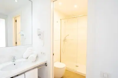 a bathroom with a shower and a sink and a toilet at Ona Living Barcelona in Hospitalet de Llobregat