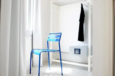 a blue chair sitting in front of a window at Express by gaiarooms in Barcelona