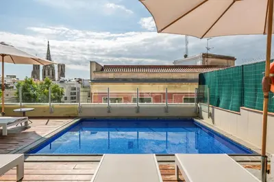 a swimming pool on the roof of a building at Aspasios Catedral Apartments in Barcelona