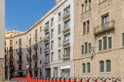 a large brick building next to a street at Aspasios Catedral Apartments in Barcelona