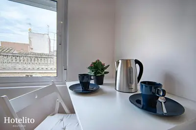 a counter with two cups and a coffee maker on it at Hotelito Boutique Badalona. in Badalona